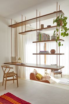 a living room filled with furniture and bookshelves in front of a large window