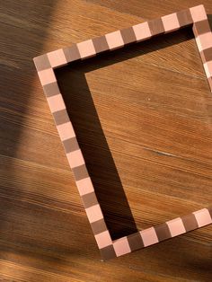 a square shaped object sitting on top of a wooden table