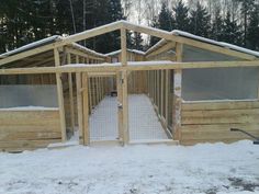 a chicken coop with snow on the ground