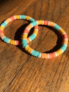 This bracelet is called sunset breeze. It includes teal, yellow, orange, light orange, and white clay beads. If you have any questions message me. Playful Orange Bracelets For Beach, Orange Heishi Beads Bracelets For Beach, Handmade Orange Heishi Beads Friendship Bracelets, Sunset Clay Bead Bracelet, Orange Clay Bead Bracelets, Sunset Bracelet, Homemade Bracelets, Clay Bead Bracelet, Bracelet Inspo