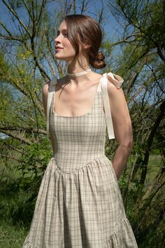 Ready to ship A truly special dress. Classic sage plaid with cream ribbon ties make this warm weather Mirabelle a timeless heirloom piece that will always be in style. With a full corseted bodice, and sweeping ruffle hem -- the Mirabelle Dress is dramatic, romantic beauty at its best. DETAILS: Pockets, of course! Lined bodice with boning, ribbon-tie straps, side zip and ruffle hem. FIT: Structured bodice with "held in" fit, easy fit across hips. Full skirt hits at mid-calf, fits most petites wit Ribbon Strap Dress, Lenin Dress, Dramatic Romantic, Heirloom Dresses, Special Dress, Special Dresses, Smallville, 가을 패션, Ribbon Tie