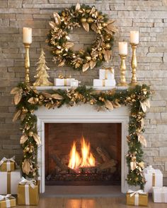 a fireplace decorated for christmas with candles and presents