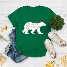 "Christmas Polar Bear Lights Shirt, Christmas Tee, Funny Christmas Shirt, Christmas Gift Shirt, Christmas Gift For Her, Christmas Family Tee Light up your holiday spirit with our 'Christmas Polar Bear Lights' Shirt. This funny Christmas tee features a playful polar bear wrapped in festive lights. It's a delightful Christmas gift shirt, perfect for adding some whimsy to the season. Share the laughter with this Christmas gift for her, and make it a part of your Christmas family tee collection.  #HolidayLaughs Hi!  Welcome. It's great to see you here! ☺️ Our shirts are clean, high quality and soft. It is prepared quickly by our boutique.  Ironing and shipped.  Enjoy your shopping! It is a pleasure for us to help you with your questions and you can reach us at any time. Please, don't forget to Christmas Polar Bear, Mint Shirt, Christmas Shirt Funny, Text Shirt, Family Tees, Christmas Gift For Her, Funny Christmas Shirts, Christmas Family, Christmas Tees