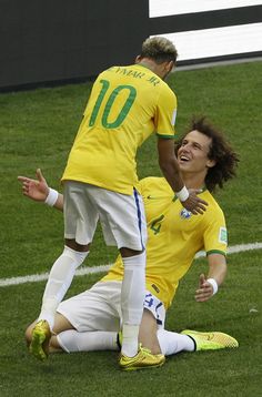 two soccer players are celebrating on the field