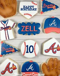 decorated cookies are arranged in the shape of baseballs, hats, and mitts