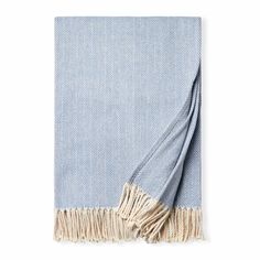 a blue and white blanket with fringes