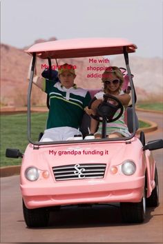 two people riding in a pink golf cart