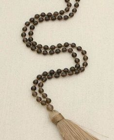 108 smoky quartz gemstone beads are knotted together to create a healing mala. Smoky quartz is said to have grounding and detoxifying effects, and is used for soothing pain of all sorts. An additional guru bead assists with counting and lets you know when you’ve completed one round of prayers. Quartz beads are about 6mm, guru bead is about 8mm. Knotted gemstone mala 108 smoky quartz beads Gemstone beads are about 6 mm each Additional guru bead is about 8 mm For meditation use only, not recommend Meditation Beads Mala, Mala Bead Necklace, Mala Meditation, 108 Bead, Quartz Beads, Mala Necklace, Mala Beads, Prayer Beads, Smoky Quartz