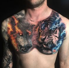 a man with tattoos on his chest has two wolfs painted on it's chest