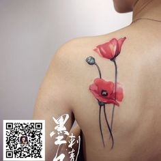 a woman's back with red flowers painted on it