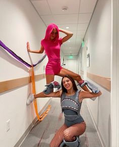 two women in tights and heels are doing aerial tricks on the floor with their hands