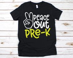 a black t - shirt with the words peace out prek written in yellow on it