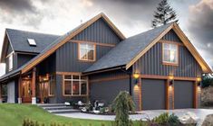 a large gray house with lots of windows on the front and side of it's roof