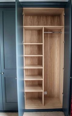 an empty closet is shown with shelves and drawers in it's blue painted walls