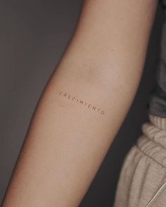 a woman's arm with the word cremementoo tattooed on her left arm