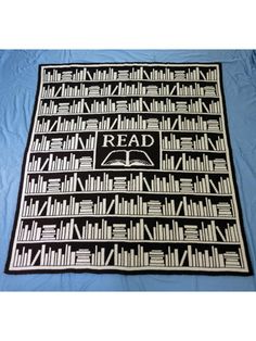 a black and white rug with books on it that says read in front of a blue background