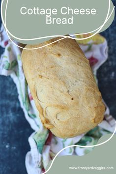 a loaf of cottage cheese bread sitting on top of a floral cloth with the words cottage cheese bread above it