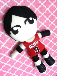 a black and white stuffed animal wearing a red shirt with the number 3 on it