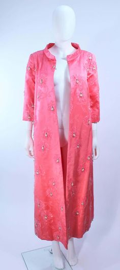 For Sale on 1stDibs - This coat is composed of a vibrant pink silk with faux pearl applique and bow design. Features center front hook and eye closures and belt. In excellent Elegant Pink Silk Outerwear, Elegant Pink Outerwear For Festive Occasions, Elegant Pink Festive Outerwear, Elegant Pink Outerwear For Wedding, Pearl Applique, Opera Coat, Bow Design, Pink Silk, Faux Pearl