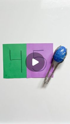 a piece of paper with the word h on it next to a pair of scissors