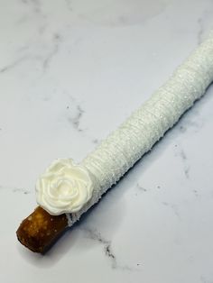 a close up of a piece of food on a marble counter top with white frosting