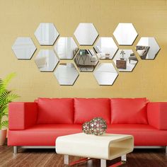 a living room with red couches and mirrors on the wall