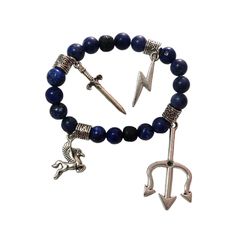 a bracelet with an anchor, horse and arrow charm on the clasp is shown against a white background