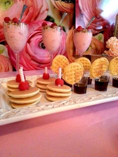 a table topped with waffles and drinks