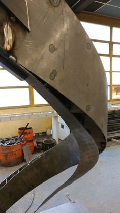 a large metal object in a building with lots of steel work on it's sides