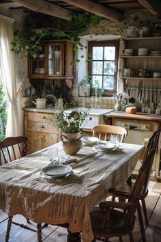 a table with plates and cups on it in a kitchen