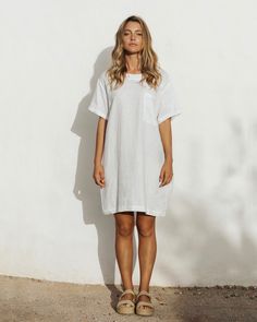 Easy breezy. That is the feeling you get when wearing a linen T-Shirt dress MIJAS in White. Perfectly balanced for summer strolls – it keeps you cool and protects your skin from s. Easy to style – wear it alone with sandals or sneakers, on a colder day – pair it with l linen pants.• T-shirt style dress • 2 side seam pockets, 1 front pocket • Medium weight linen (approx. 180 gsm) Wrinkled Clothes, Light Coral, Linen Tshirts, Rich Color Palette, Minimalist Wardrobe, Shirt Dress Style, T Shirt Style, Easy Breezy, Clothing Care