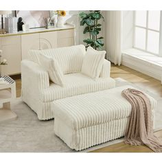 a white couch and ottoman in a room