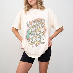 Step into the groove with our "Living Young, Wild, Free" oversized retro mushroom shirt, perfect for embracing your bohemian spirit and free-spirited style! 🍄✨ Crafted with love and care, this groovy tee exudes retro vibes with its whimsical mushroom design and bold slogan, making it a must-have addition to any hippie-inspired wardrobe. Whether you're lounging at home, exploring the great outdoors, or hitting up your favorite music festival, this shirt is sure to turn heads and spread good vibe Oversized Retro T-shirt For Spring, Retro Oversized Shirt With Letter Print, Casual Relaxed Fit T-shirt With Retro Print, Casual Retro Print Relaxed Fit T-shirt, Retro Printed T-shirt With Relaxed Fit, Relaxed Fit Short Sleeve T-shirt With Retro Print, Summer Relaxed Fit Shirt With Mushroom Print, Retro Print Short Sleeve Top With Relaxed Fit, Relaxed Fit Retro Print Short Sleeve Tops