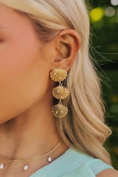 Go for a stylish beachy vibe with these chic earrings! - Gold colored material with faux pearl accents - A seashell stud with dangling seashells design - Post and backs - Length: 2.6 inches Chic Earrings, Jean Accessories, Holiday Trends, Fairytale Dress, Midi Dress Party, Denim Trends, Shell Earrings, Lace Fashion, Earrings Gold