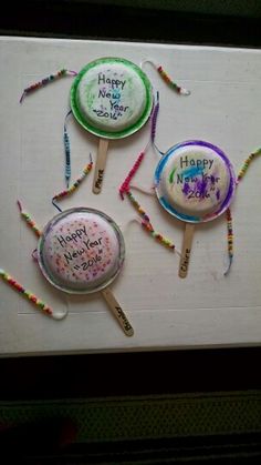 three lollipops with happy new year written on them