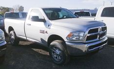 a white ram truck parked in a parking lot