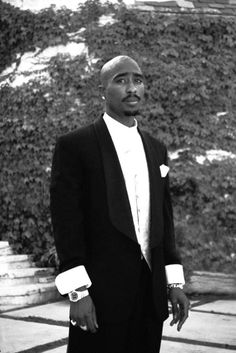 a man in a black suit and white shirt