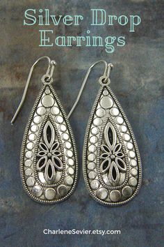 Discover the magic of bohemian style with these silver flower earrings! These boho chic silver teardrop earrings are the perfect accessory to complete your unique boho wardrobe. Make a statement and impress everyone with this one-of-a-kind Silver Jewelry Gift. Get your pair today! Bohemian Silver Filigree Teardrop Earrings, Bohemian Teardrop Earrings With Intricate Design, Boho Wardrobe, Earrings Boho Chic, Unique Silver Jewelry, Customizable Jewelry, Silver Flower Earrings, Board Pin, Boho Chic Style