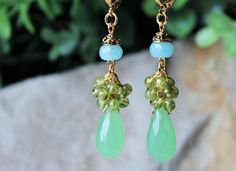 "Limited Statement Earrings Collection. Elegant, opulent, and shimmery, these show stopping earrings feature a bright, rich palate. The bottom fringe features beautiful green Chalcedony tear drop gemstone with cluster of small aqua blue quartz and green peridot gemstones. Hanging from a surgical steel lever-back, it measures 2.5 \" in length. . These luxury earrings are bold and beautiful, and make a powerful statement. These gorgeous chandelier earrings are unique, feminine and eye-catching, a Chandelier Long, Green Chalcedony, Luxury Earrings, Earrings Green, Peridot Gemstone, Green Peridot, Blue Quartz, Cluster Earrings, Gift Handmade