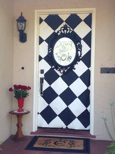 the front door is decorated with black and white checkerboard