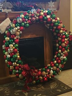 a christmas wreath sitting in front of a fire place