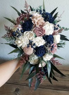 a bridal bouquet with blue, pink and white flowers