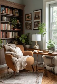 a living room filled with furniture and bookshelves next to a window covered in plants