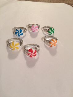 six rings with candy canes on them sitting on a white table top next to each other