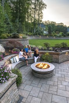 several people sitting around an outdoor fire pit