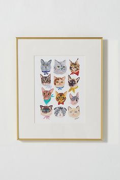 a white wall with a gold frame and various cats in different colors on it's side