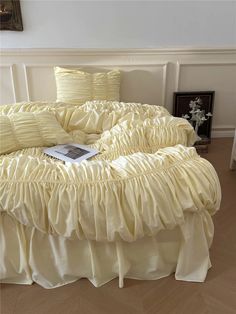 a bed with yellow ruffled bedspread and pillows