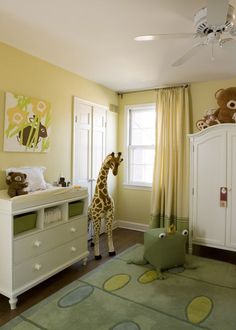 a giraffe standing in the middle of a bedroom next to a dresser and bed