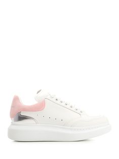 White calfskin oversize sneaker with metallic silver panel and contrasting petal pink heel from Alexander McQueen. Alexander McQueen embossed signature on the heel and chunky rubber sole. Pink Leather Chunky Sneakers With Rubber Sole, Pink Leather Low-top Chunky Sneakers, Pink Leather High-top Platform Sneakers, Pink High-top Leather Platform Sneakers, Pink Leather Platform Sneakers With Round Toe, Pink Leather Chunky Sneakers For Streetwear, Pink Leather Platform Sneakers For Streetwear, Pink Leather Platform Sneakers With Rubber Sole, Luxury Patent Leather Low-top Sneakers