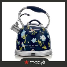 a blue tea kettle with flowers on it and the words, laria ashley